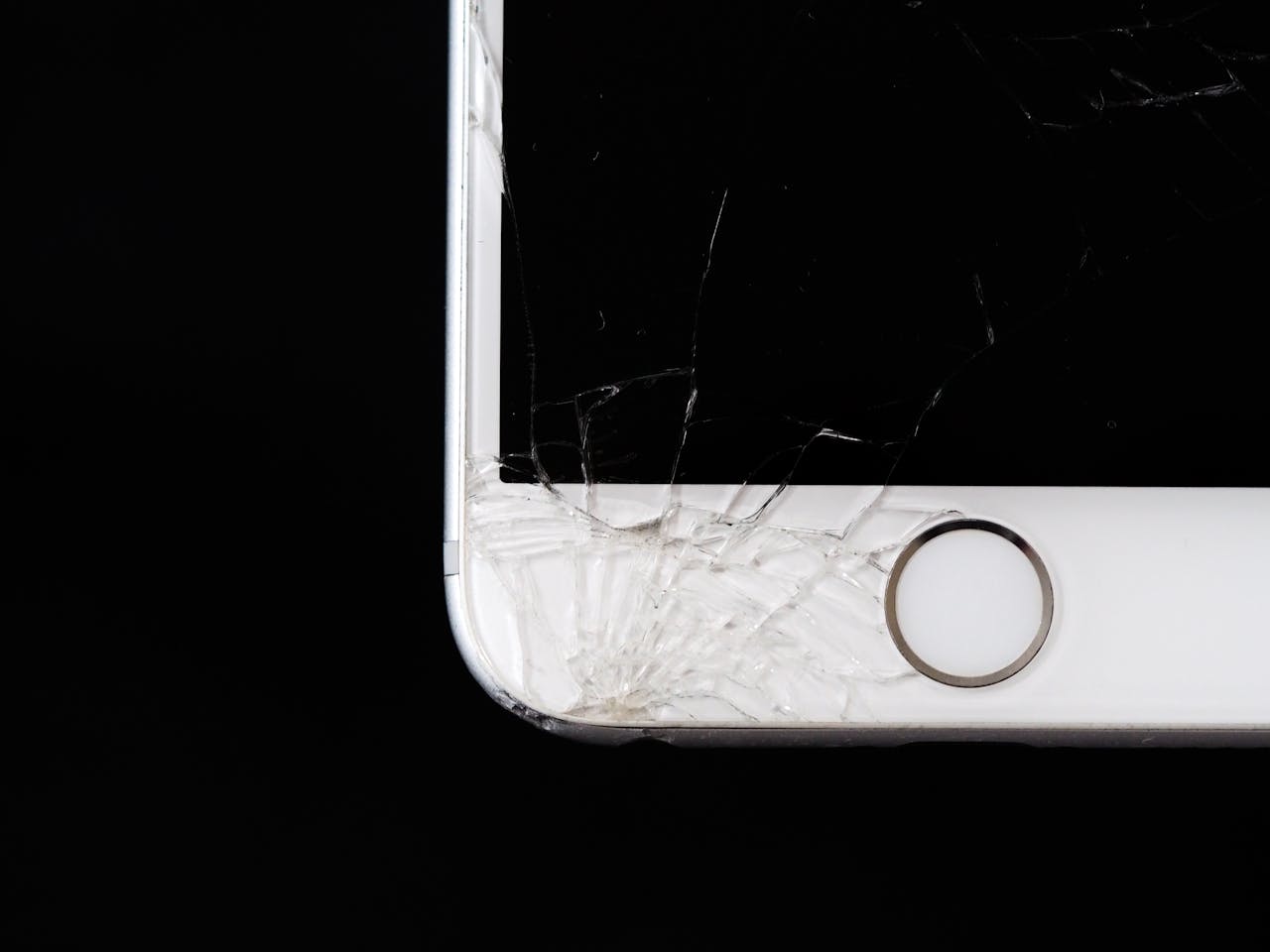 Detailed image of a cracked smartphone screen highlighting damage to the device.